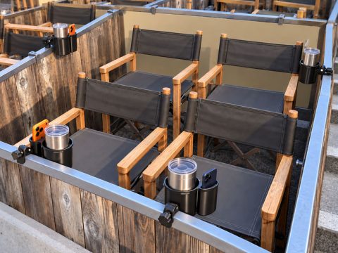 Cup and phone holders attached to the railings of a Hollywood Bowl box