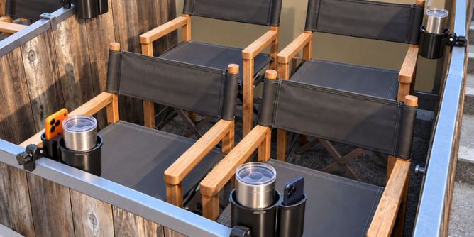 Cup and phone holders attached to the railings of a Hollywood Bowl box